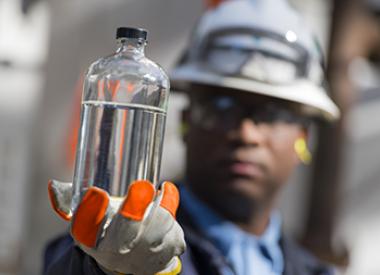 Royal Dutch Shell Employee Inspecting oil