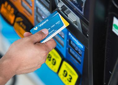 Customer with Royal Dutch Shell card at gas pump